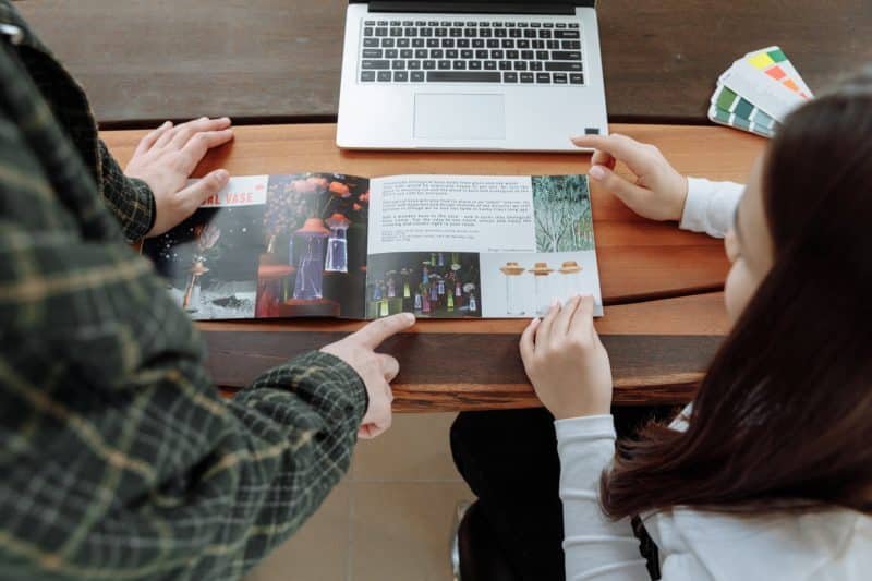 man and woman discussing about the brochure information